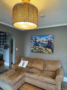 Mountain painting over couch in living room